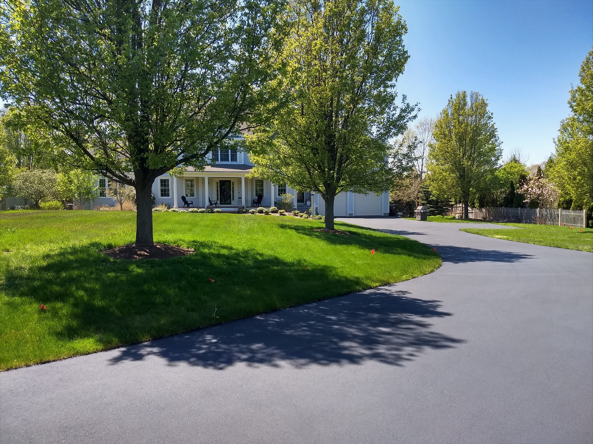A beautiful driveway, beautiful yard, beautiful home.