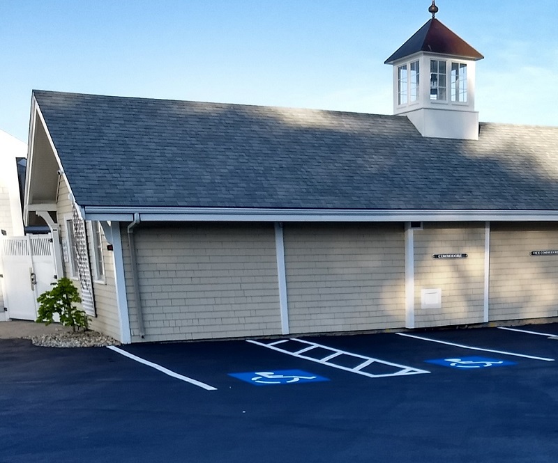 New sealcoating and line painting at Hingham Yacht club protects the asphalt, increases safety, and has tremendous curb appeal